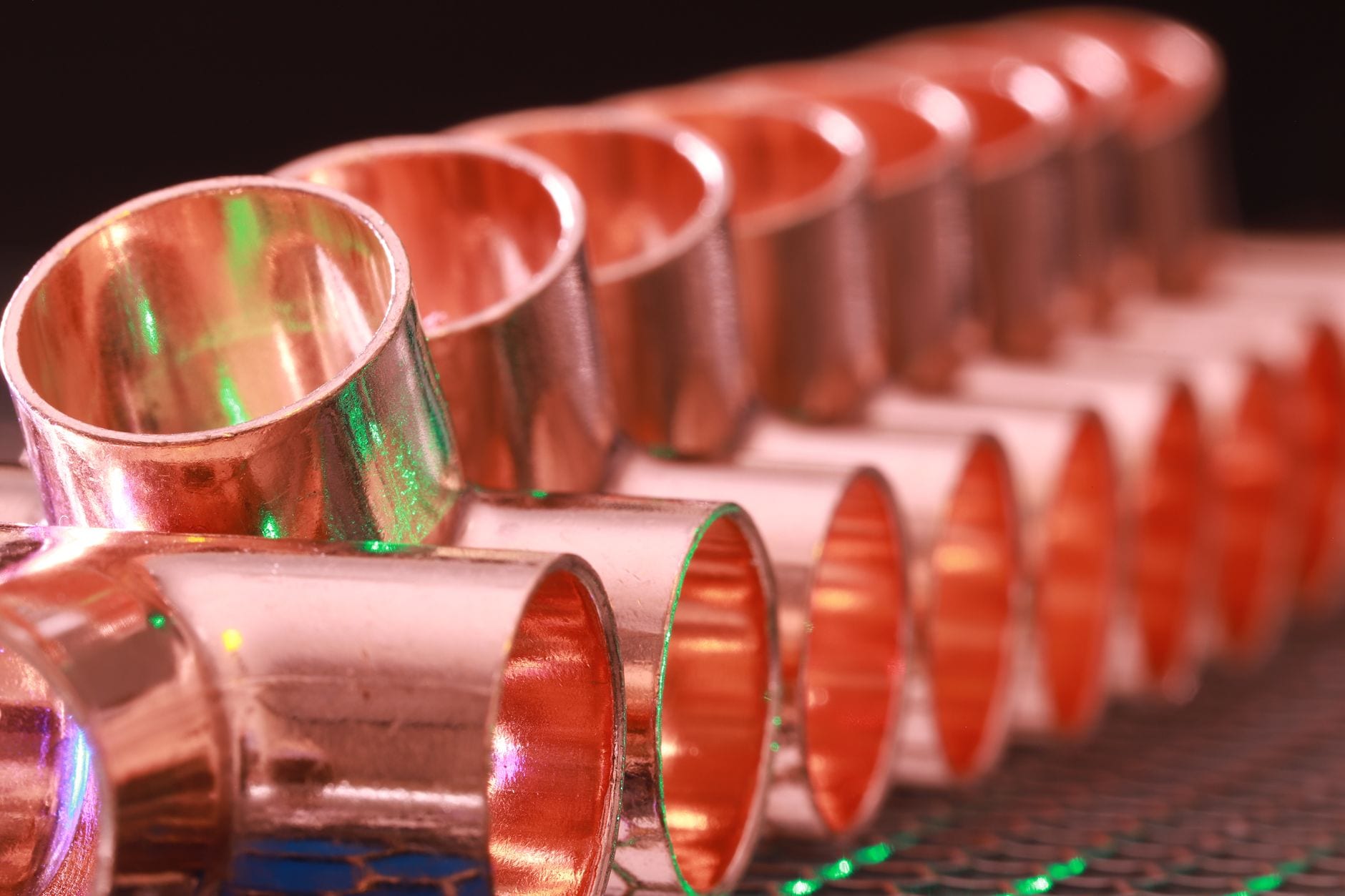Copper plumbing fittings arranged in a row